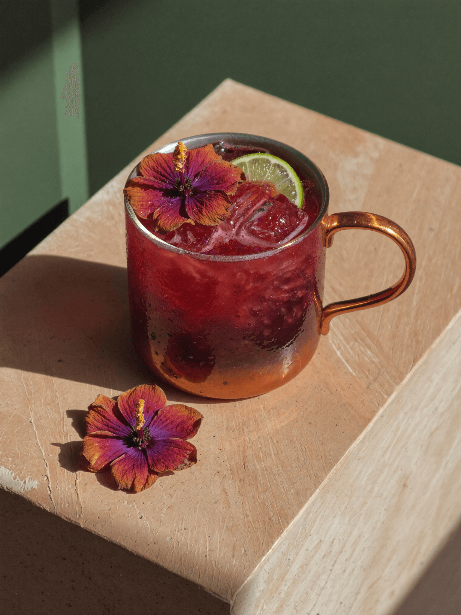 A Pombay Cane Vodka hibiscus cocktail dressed with flowers