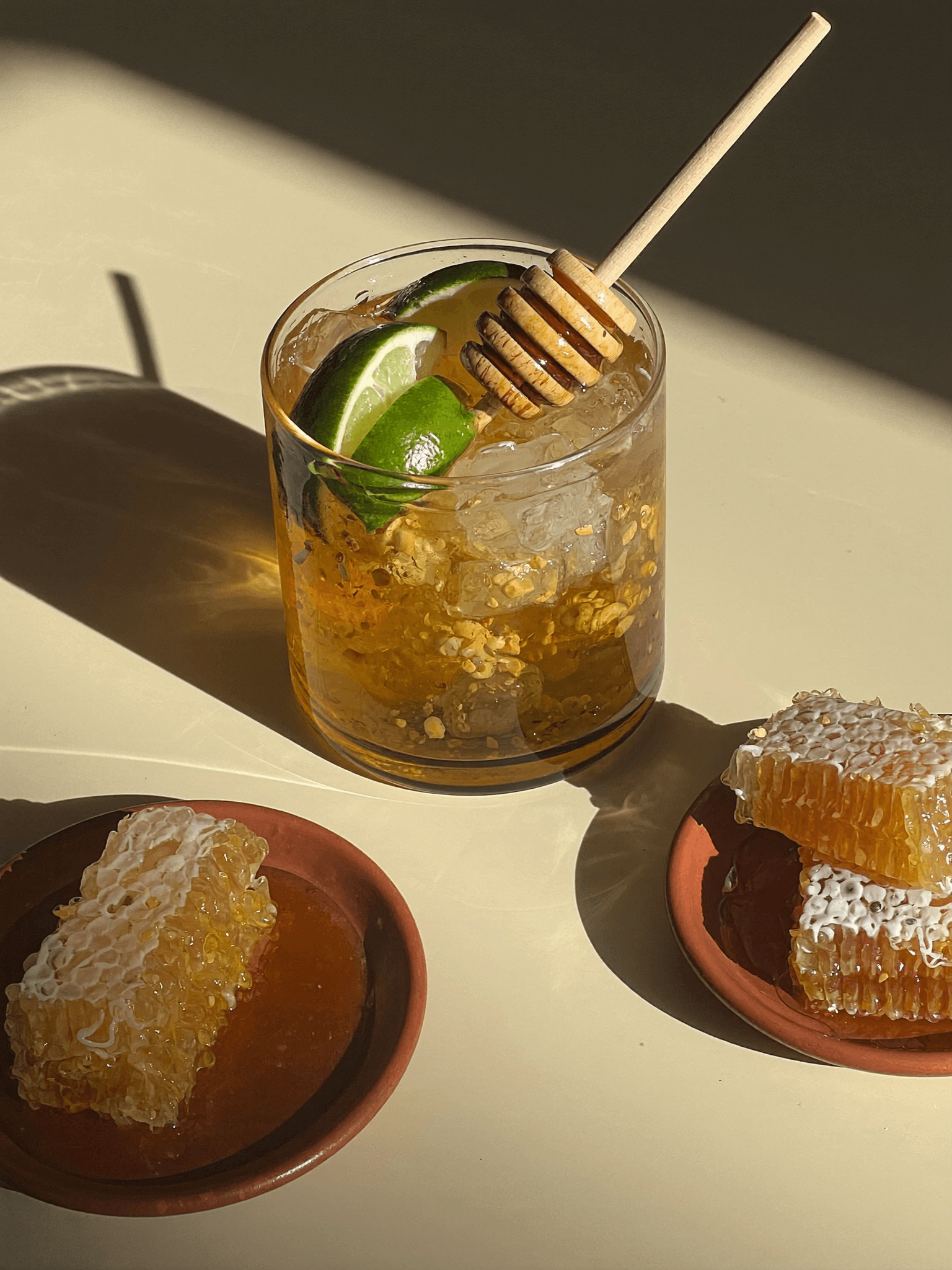 A Pombay Cane Vodka honey and lime cocktail with honeycomb