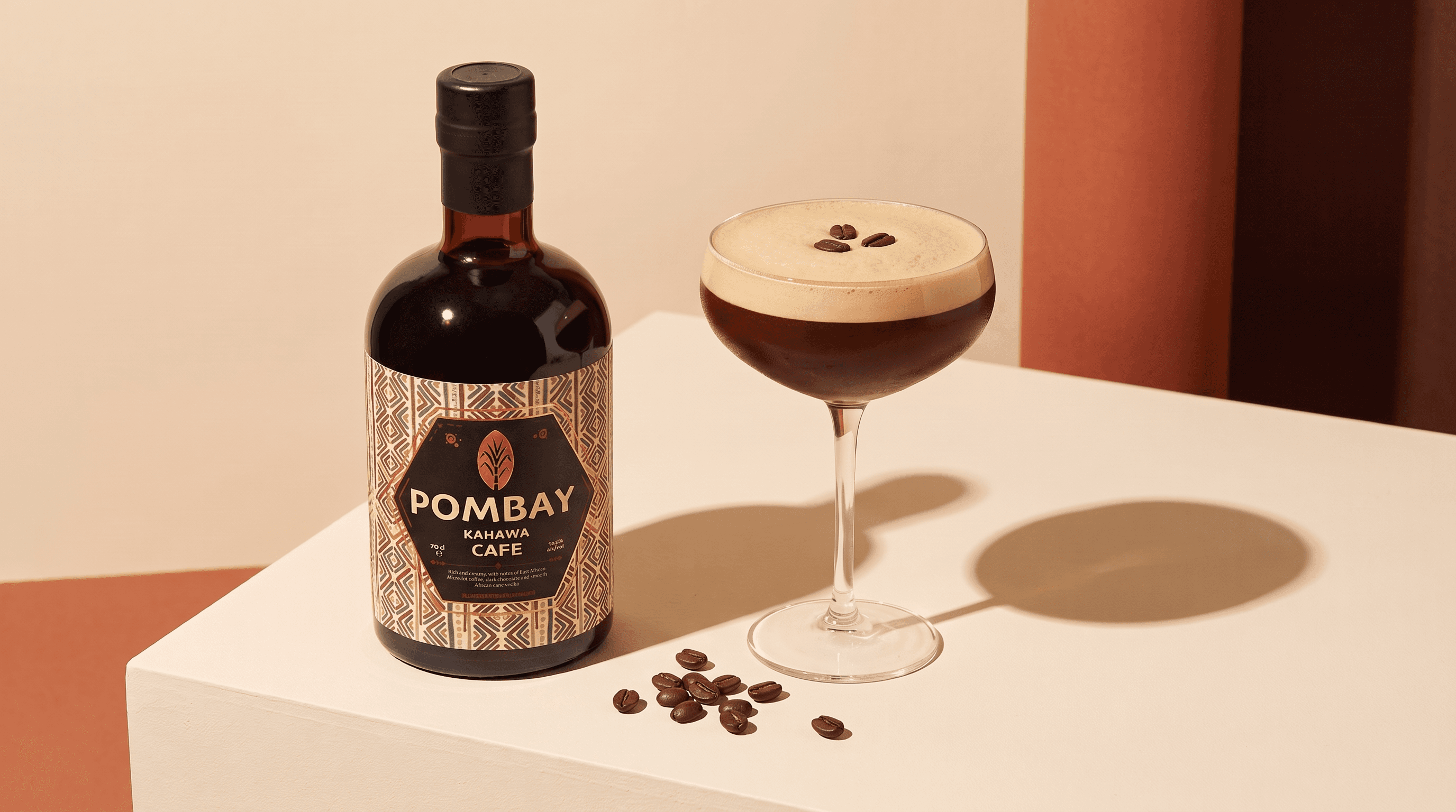 Pombay Kahawa Café Coffee Liqueur bottle beside an Espresso Martini on a warm plinth