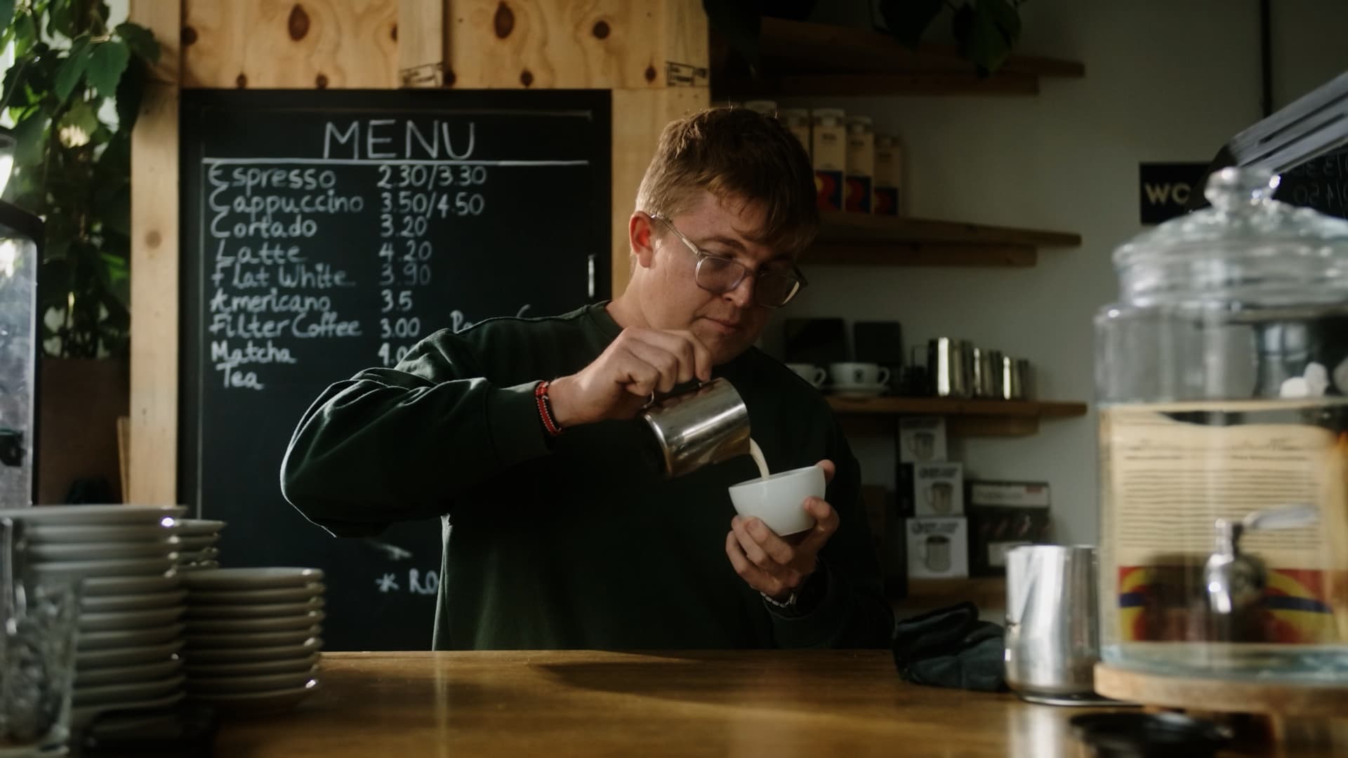 A barista pouring at the Amsterdam café where the Pombay story is told