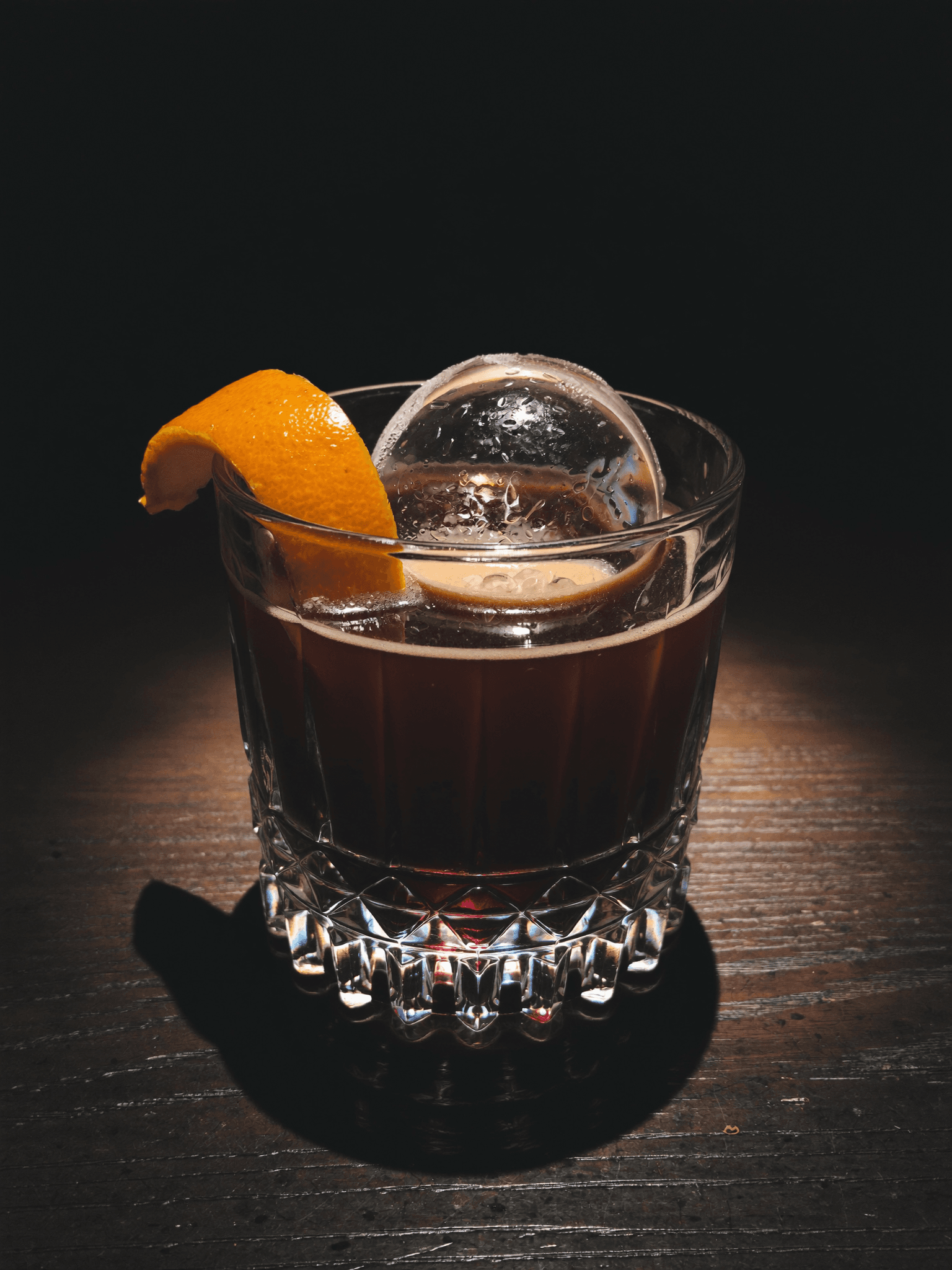 Pombay Coffee Liqueur served on the rocks with an orange twist