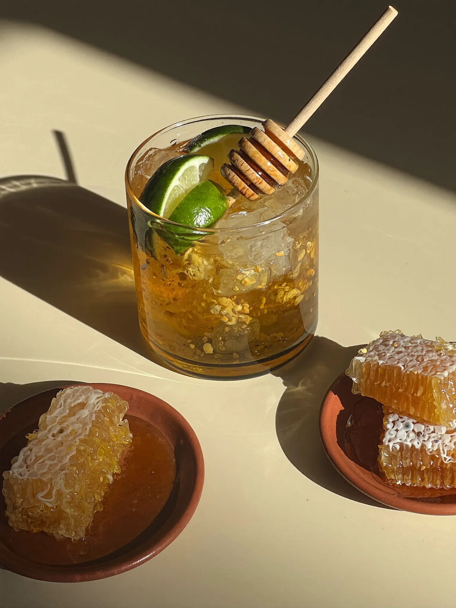 A Pombay Cane Vodka honey and lime cocktail with honeycomb
