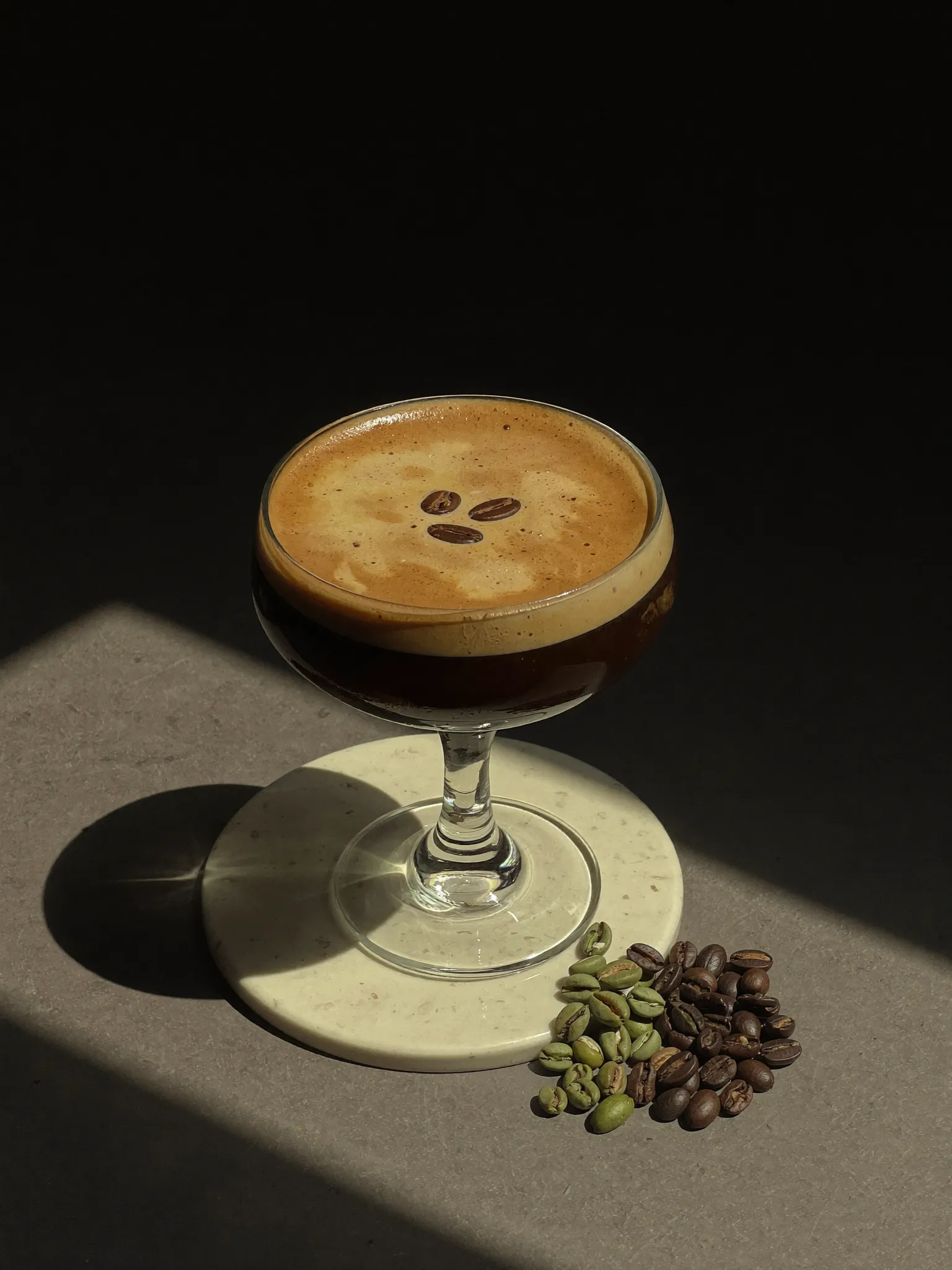 A Pombay Espresso Martini in a sunlit coupe